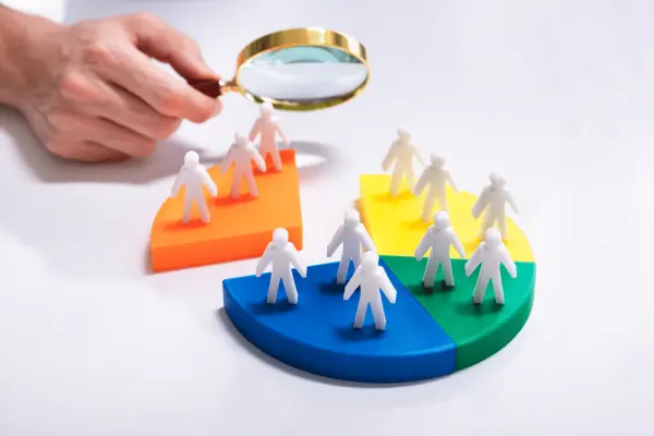 a magnifying glass showcasing market segmentation with a group of people on a pie chart